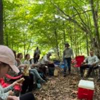 Beaver Island Participants break for lunch in the woods
